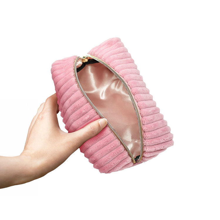 Adam & Eve EVES PLUSH STORAGE BAG - Private Storage Bag shown in hand, elegant pink plush design and satin interior.
