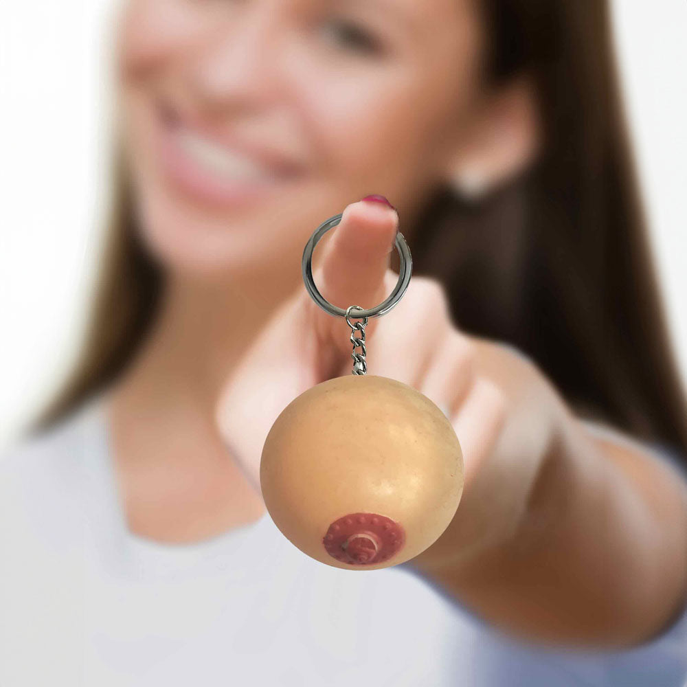 Super Fun Key Chain - Squishy Boob - Novelty Keychain held by a smiling woman, adding fun to her keyring.