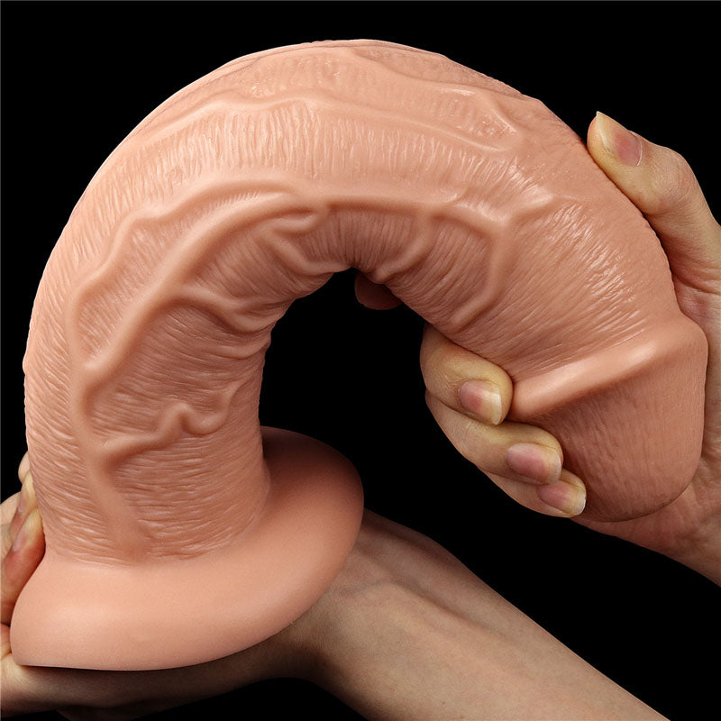 King Size 11'' Realistic Dildo -  28 cm Dong in hand, showcasing the detailed realistic texture and flexible design.