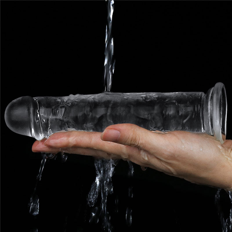 Flawless Dildo 7'' -  17.8 cm Dong held in hand with water cascading over it, highlighting its realistic design.