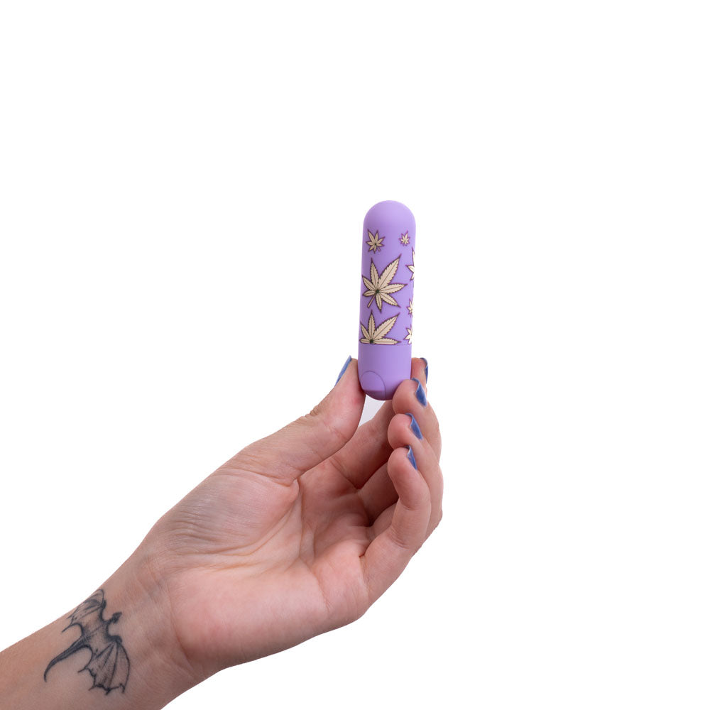 Maia Jessi 420 - Violet 7.6 cm USB Rechargeable Bullet held in hand with a hemp leaf print design.