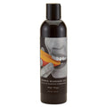 Edible Massage Oil - Mango Flavoured - 237 ml Bottle with a person smiling while holding a mango slice.