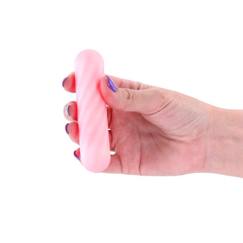 Person holding a pink USB rechargeable bullet vibrator from the X & O's Crave collection.