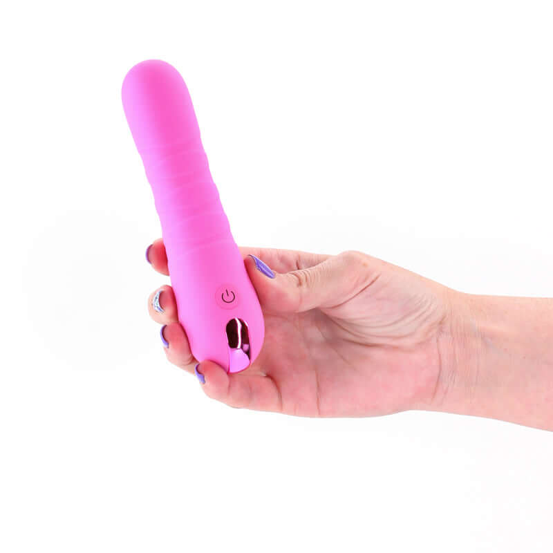 Compact pink USB rechargeable vibrator held in hand, featuring sleek design and user-friendly controls.