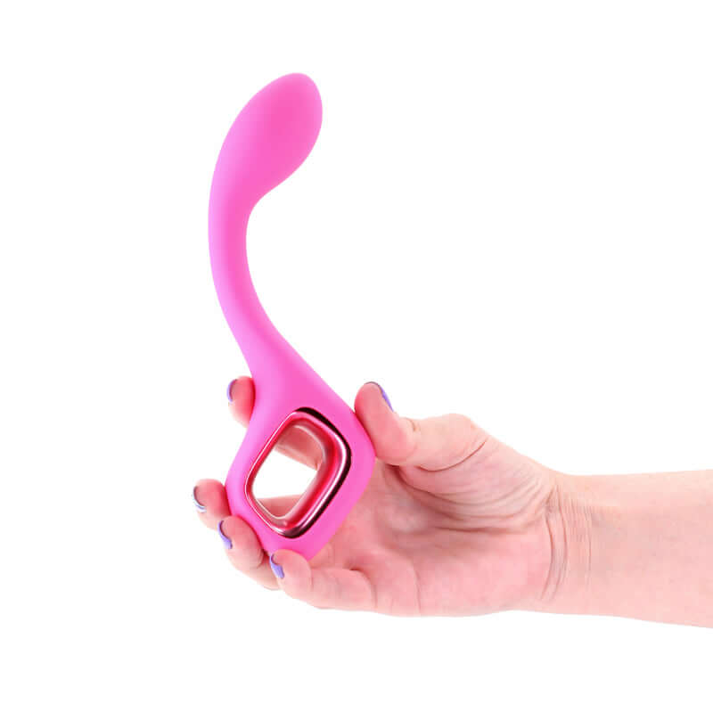 Hand holding a pink USB rechargeable G-spot vibrator with a smooth design and gently arched shape.
