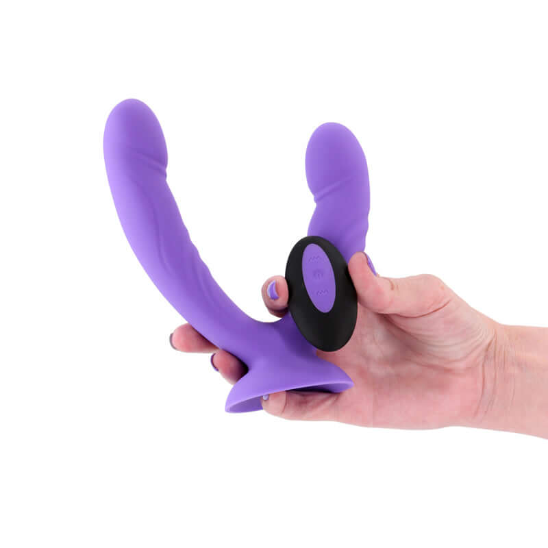 INYA Duet - USB rechargeable vibrating double dildo with remote control in hand.