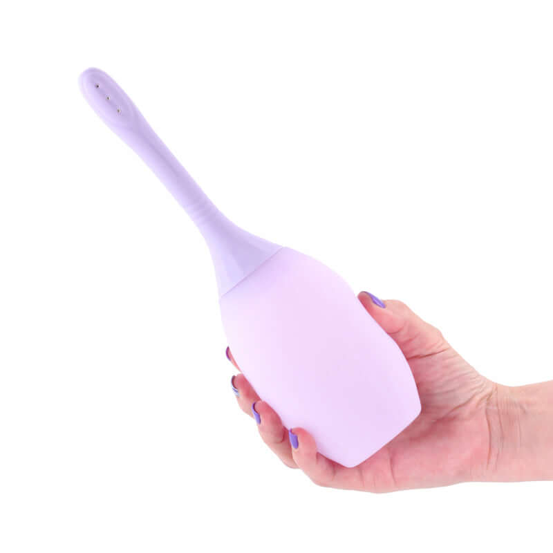 INYA Refresh unisex intimate hygiene douche held in hand, featuring a squeezable bulb and anti-backflow design.
