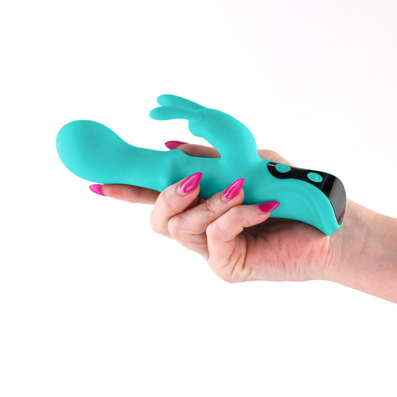 INYA Cyberluxe - Aqua - Aqua 18 cm USB Rechargeable Rabbit Vibrator with Sliding Ring Shaft held in hand.