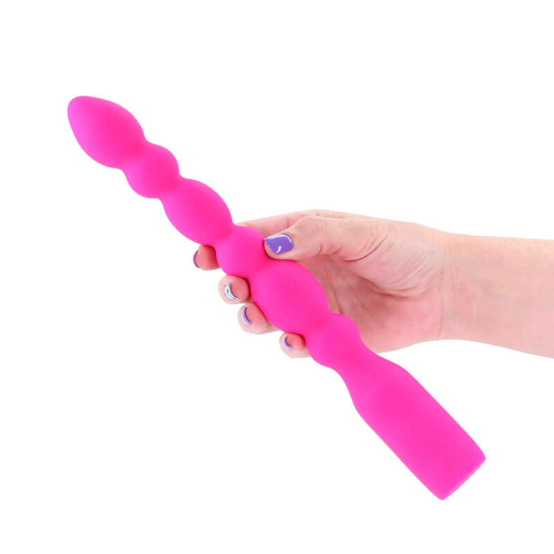INYA Prime 28.8 cm USB rechargeable anal vibrator held in a hand, showcasing its smooth pink silicone design.