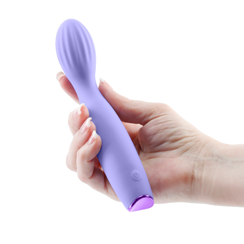 Revel Pixie -  -  17.3 cm USB Rechargeable Vibrator held in hand, showcasing its flexible design and vibrant color.