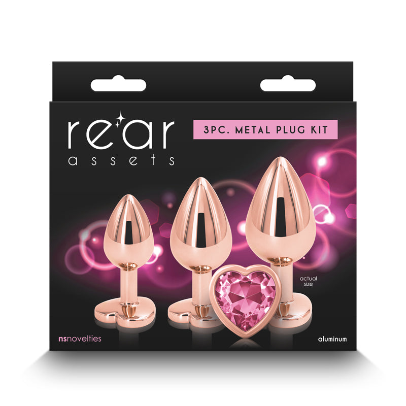 Rear Assets Trainer Kit -  - Pink Heart -  Metallic Butt Plugs with Pink Hearts - Set of 3 Sizes packaging image.