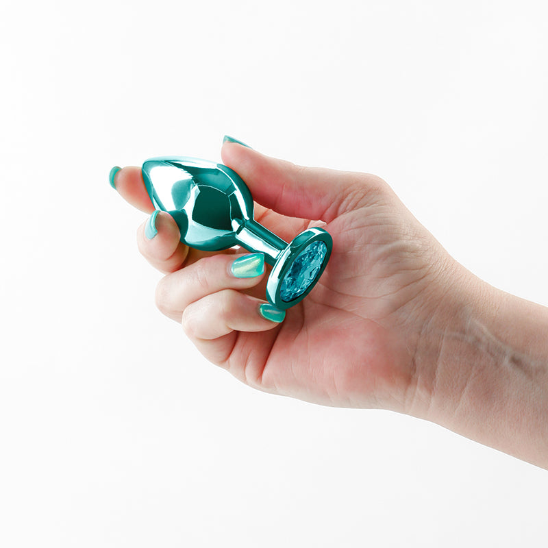 Rear Assets - Medium - Teal - Teal 8.2 cm Medium Metal Butt Plug with Teal Round Gem Base held in a hand.