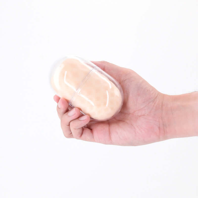 Person holding the Pocket Pals Diamond, a travel-friendly mini stroker in a compact case, designed for unique sensations.