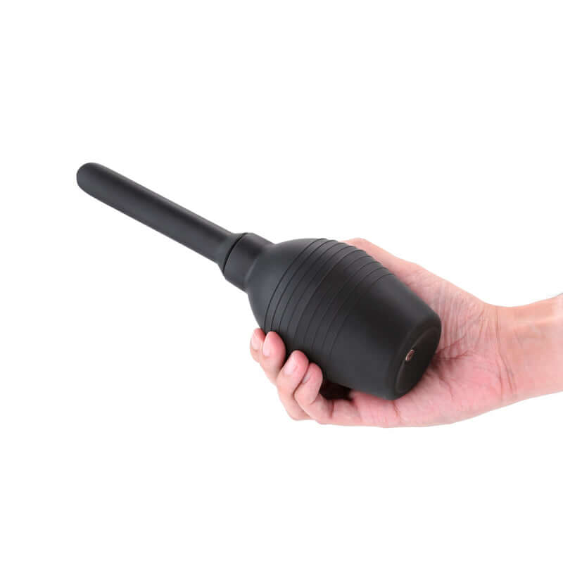 Renegade Body Cleanser 2.0 unisex intimate body cleanser in hand, featuring anti-backflow design and silicone nozzle.