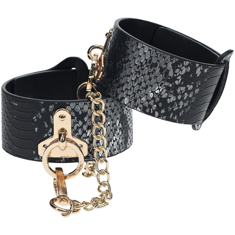 OUCH! Florence Collection - Leg Cuffs - Restraints in black with shiny snake pattern and gold chain detail.