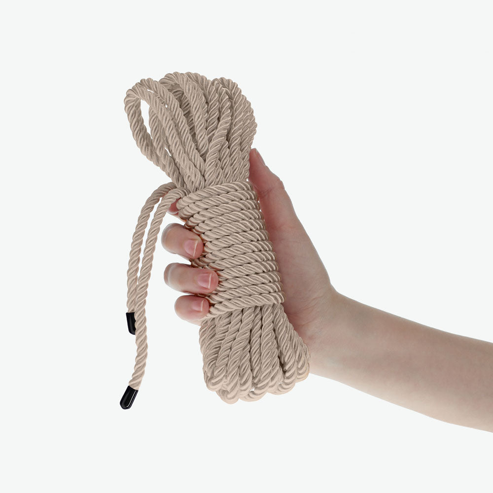 OUCH! Bondage Rope - 10 M - Gold - Gold Nylon Bondage Rope - 10 metre Length held in a hand, showcasing its strong texture.