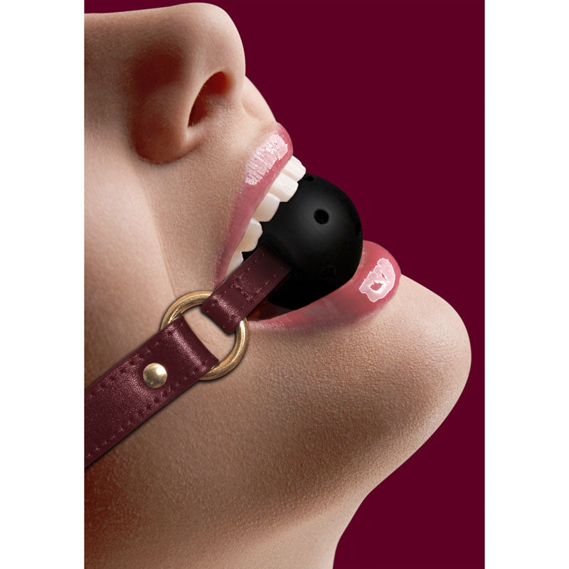 OUCH! Halo - Breathable Ball Gag - Burgundy Mouth Restraint worn, showcasing its luxurious design and functionality.