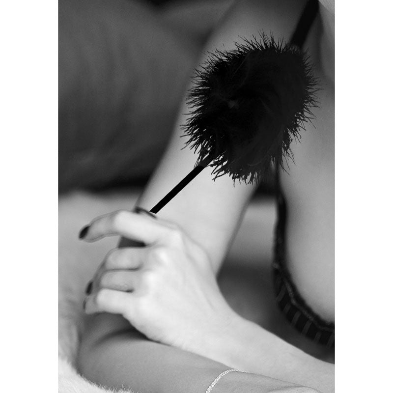 OUCH!  & White Feather Tickler -  Feather Crop enhancing intimate play with a soft black feather on a sensual background.
