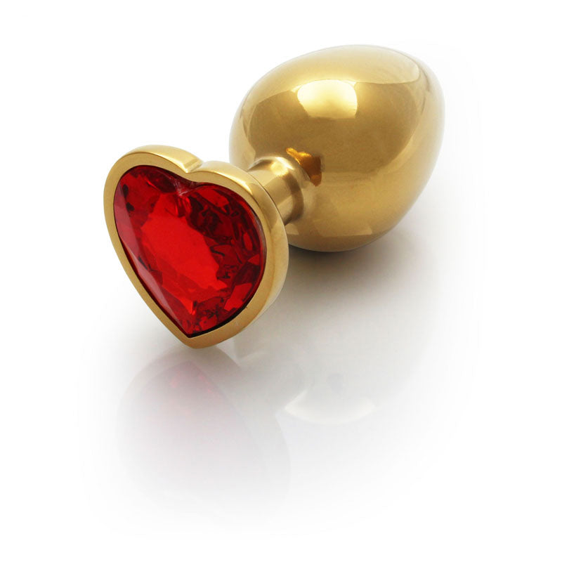 OUCH! Heart Gem Gold Butt Plug - Large - Gold 9.3 cm Large Butt Plug with Heart Gem Base on a reflective surface.