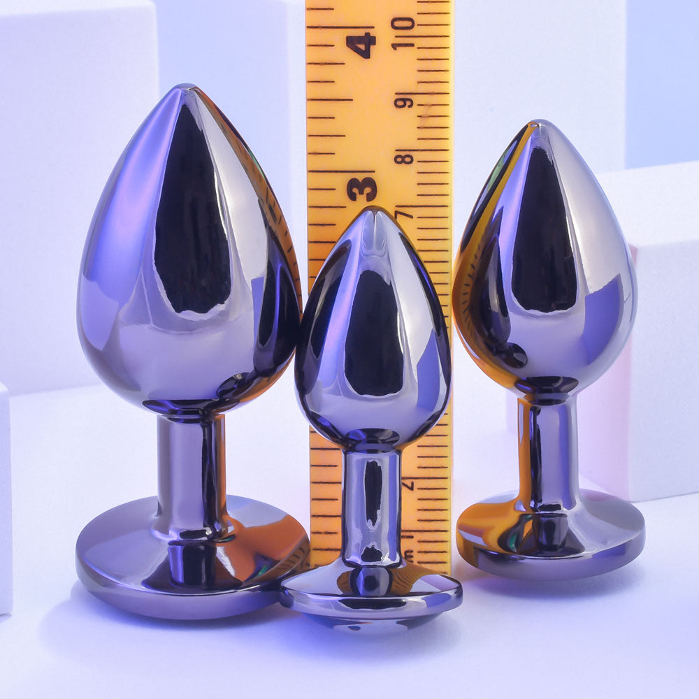 Playboy Pleasure PLEASURE 3 WAYS - Metal Butt Plugs - Set of 3 Sizes displayed with ruler for size comparison.