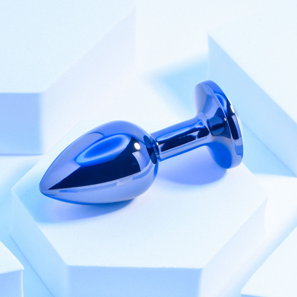 Playboy Pleasure TUX - Small - Metal 7.4 cm Small Butt Plug on a white platform with a sleek blue finish.