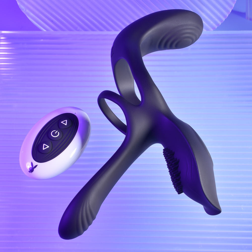 Playboy Pleasure The 3 Way -  USB Rechargeable Vibrating Cock Ring with Wireless Remote on a purple background.