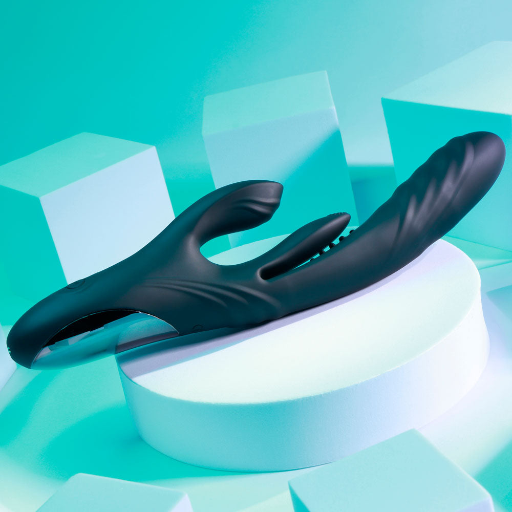 USB rechargeable rabbit vibrator displayed on a pedestal with a sleek design against a vibrant background.