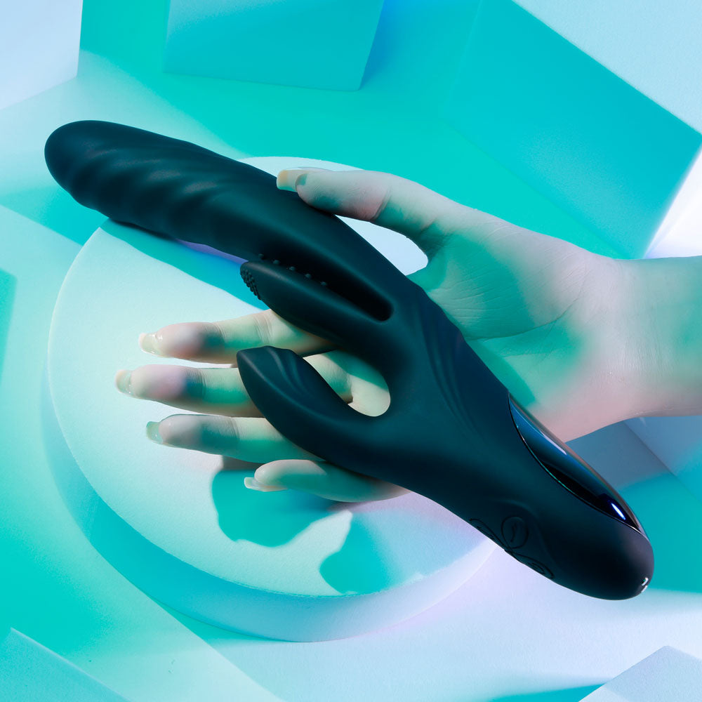 Playboy Pleasure RAPID RABBIT - 26.4 cm USB Rechargeable Rabbit Vibrator in a hand with a sleek black design.