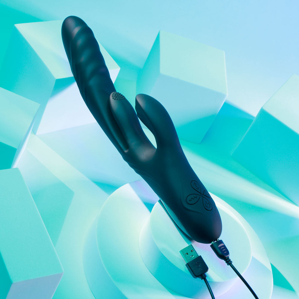 Playboy Pleasure RAPID RABBIT - 26.4 cm USB Rechargeable Rabbit Vibrator on a geometric blue background.
