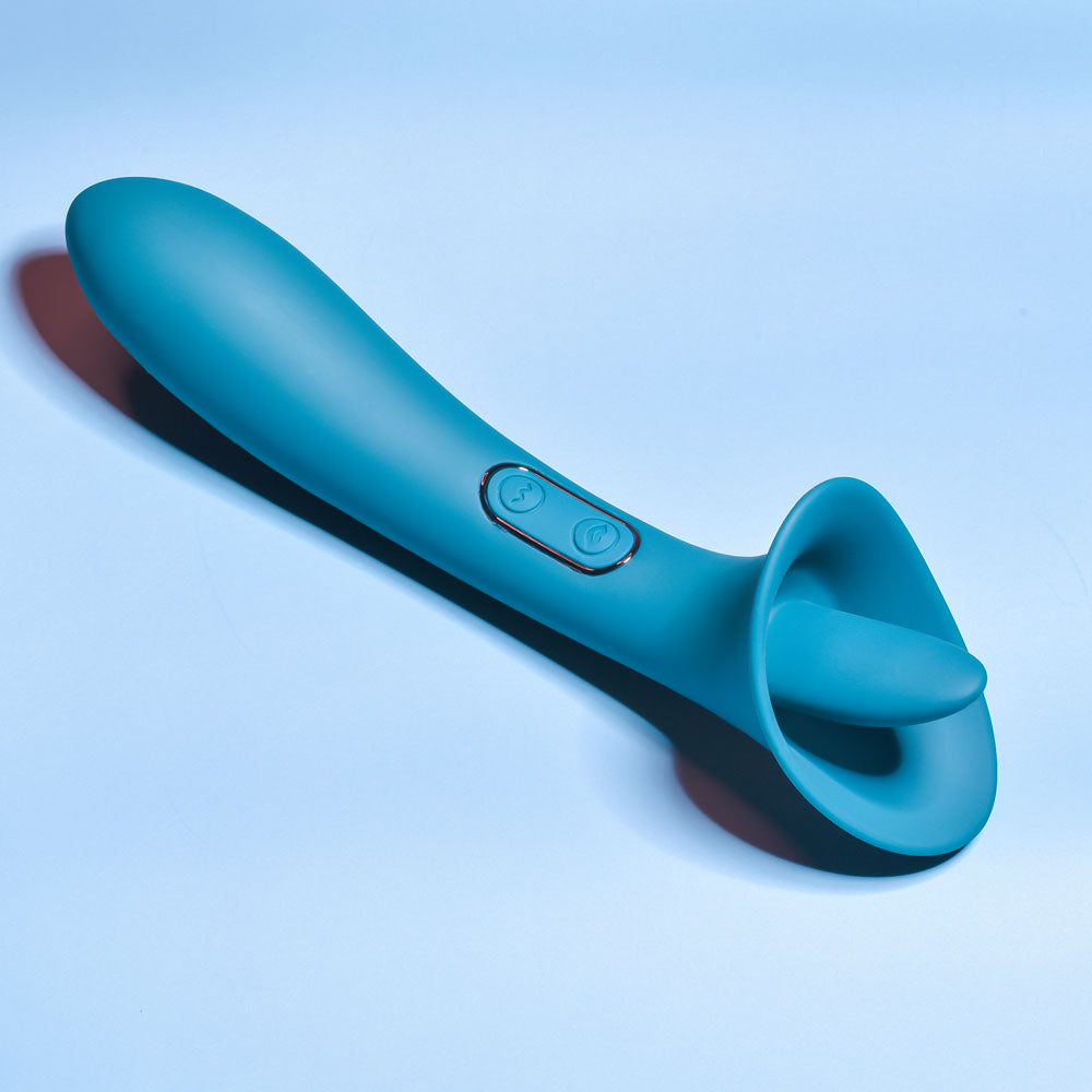 Playboy Pleasure TRUE INDULGENCE - Teal 21.3 cm USB Rechargeable Vibrator with Flicking Tip on a blue background.