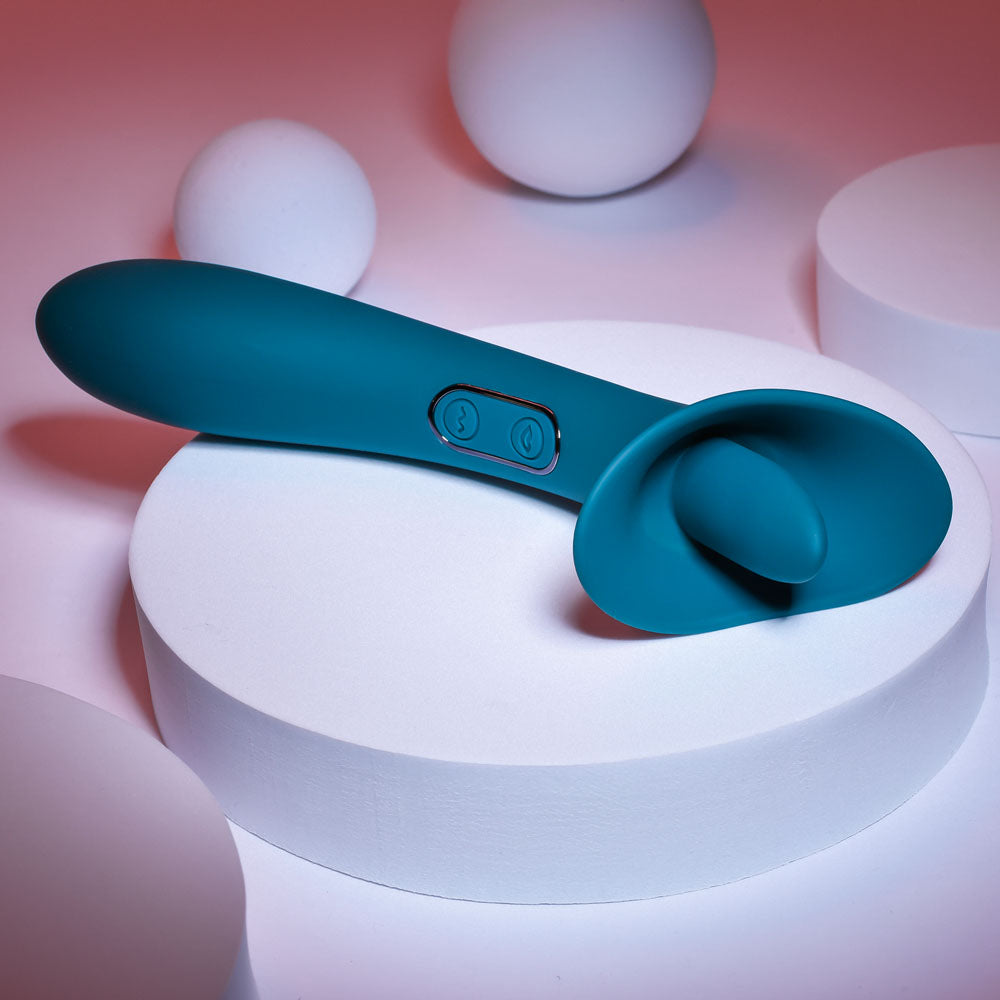 Playboy Pleasure TRUE INDULGENCE - Teal 21.3 cm USB Rechargeable Vibrator with Flicking Tip on display.