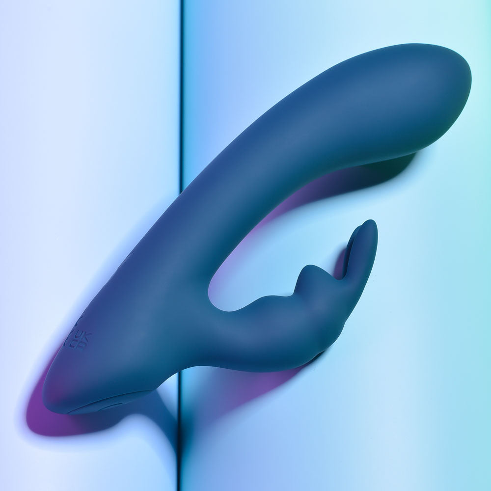 Playboy Pleasure LIL RABBIT - Deep Teal 14.6 cm USB Rechargeable Rabbit Vibrator on a colorful background.