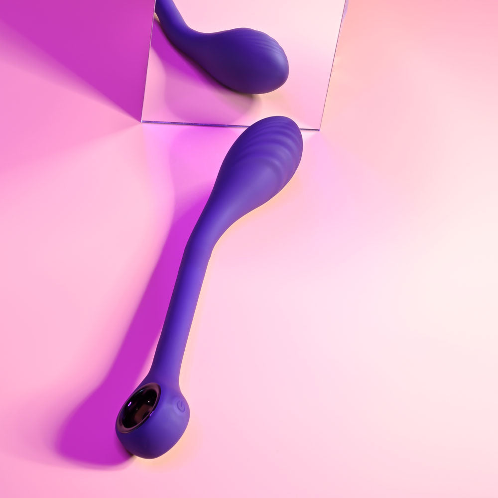 Stylish purple poseable G-Spot vibrator displayed on a pink background, showcasing its curved design and sleek finish.