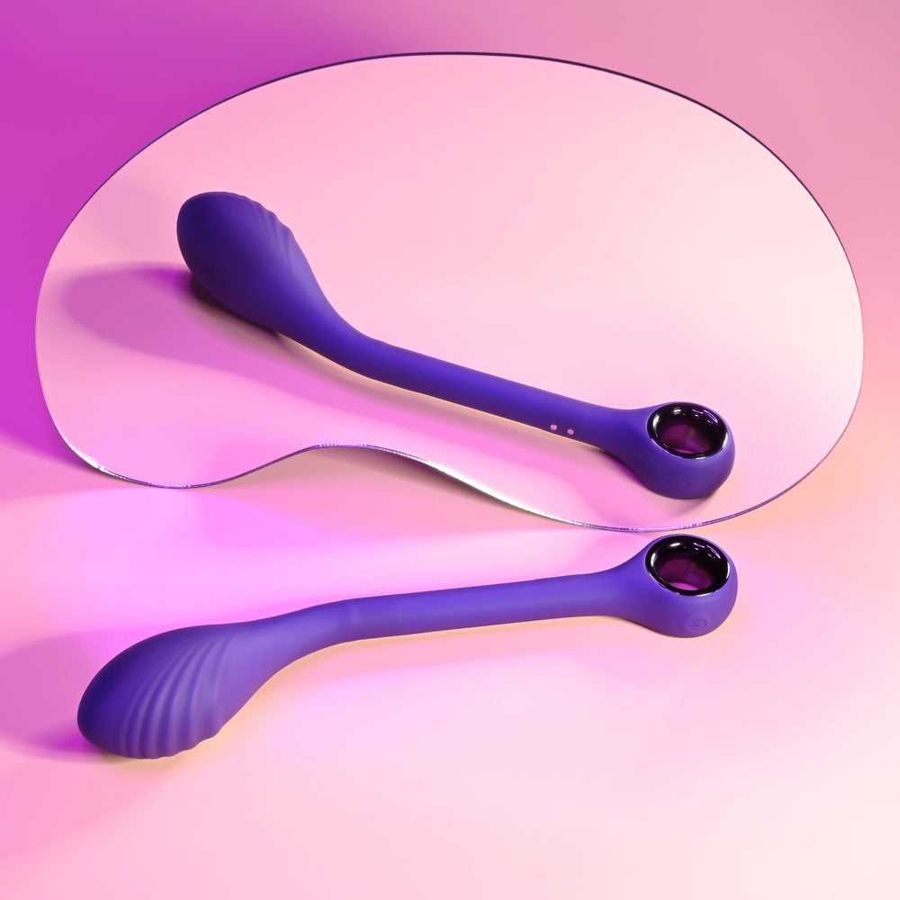 Playboy Pleasure SPOT ON 22.6 cm poseable G-Spot vibrator showcased with a reflective surface and vibrant colors.