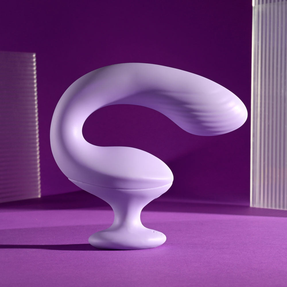 Playboy Pleasure REV ME UP -  USB Rechargeable Dual Motor Curved Vibrator on a purple background, showcasing its smooth design.