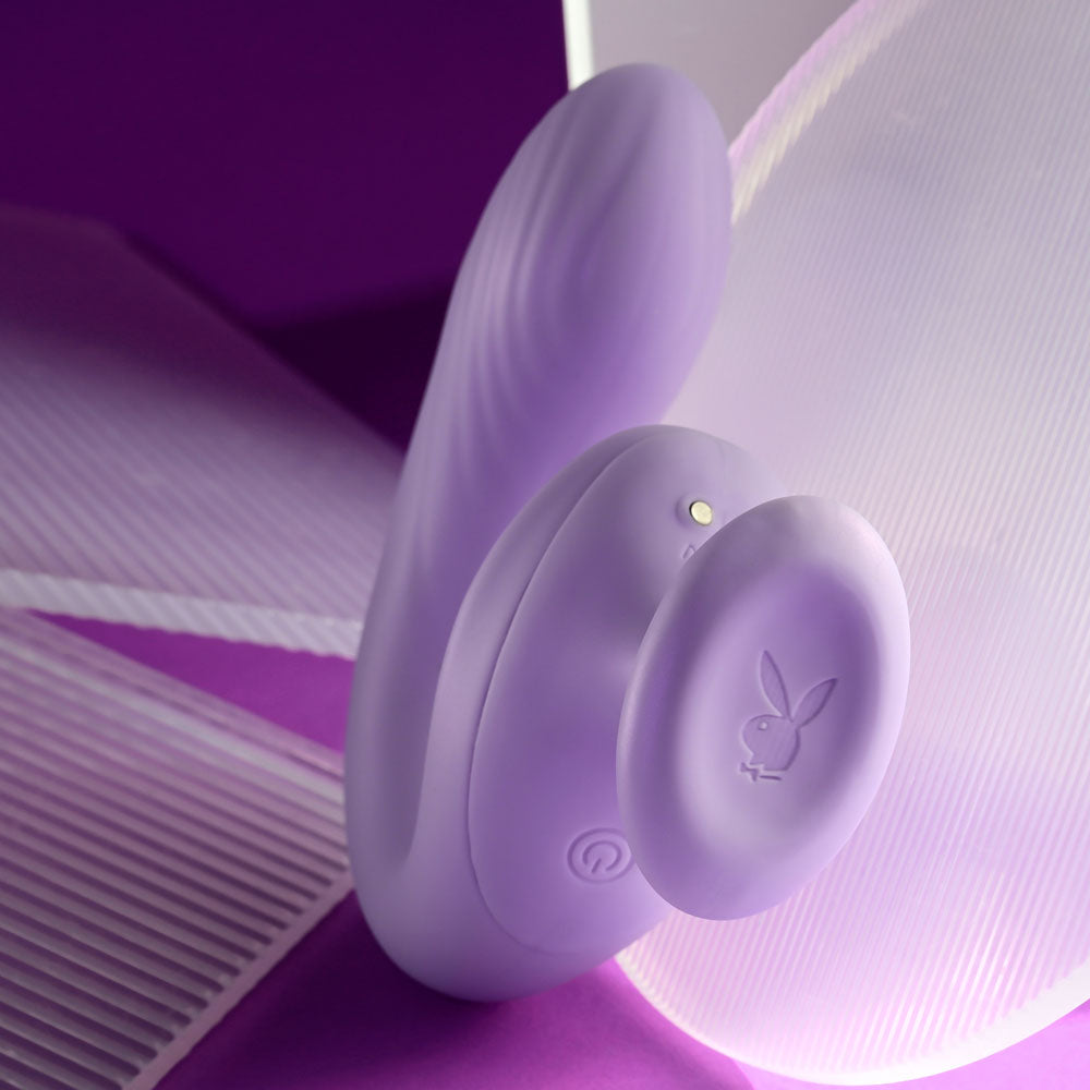 Playboy Pleasure REV ME UP -  USB Rechargeable Dual Motor Curved Vibrator in lavender on a purple background.