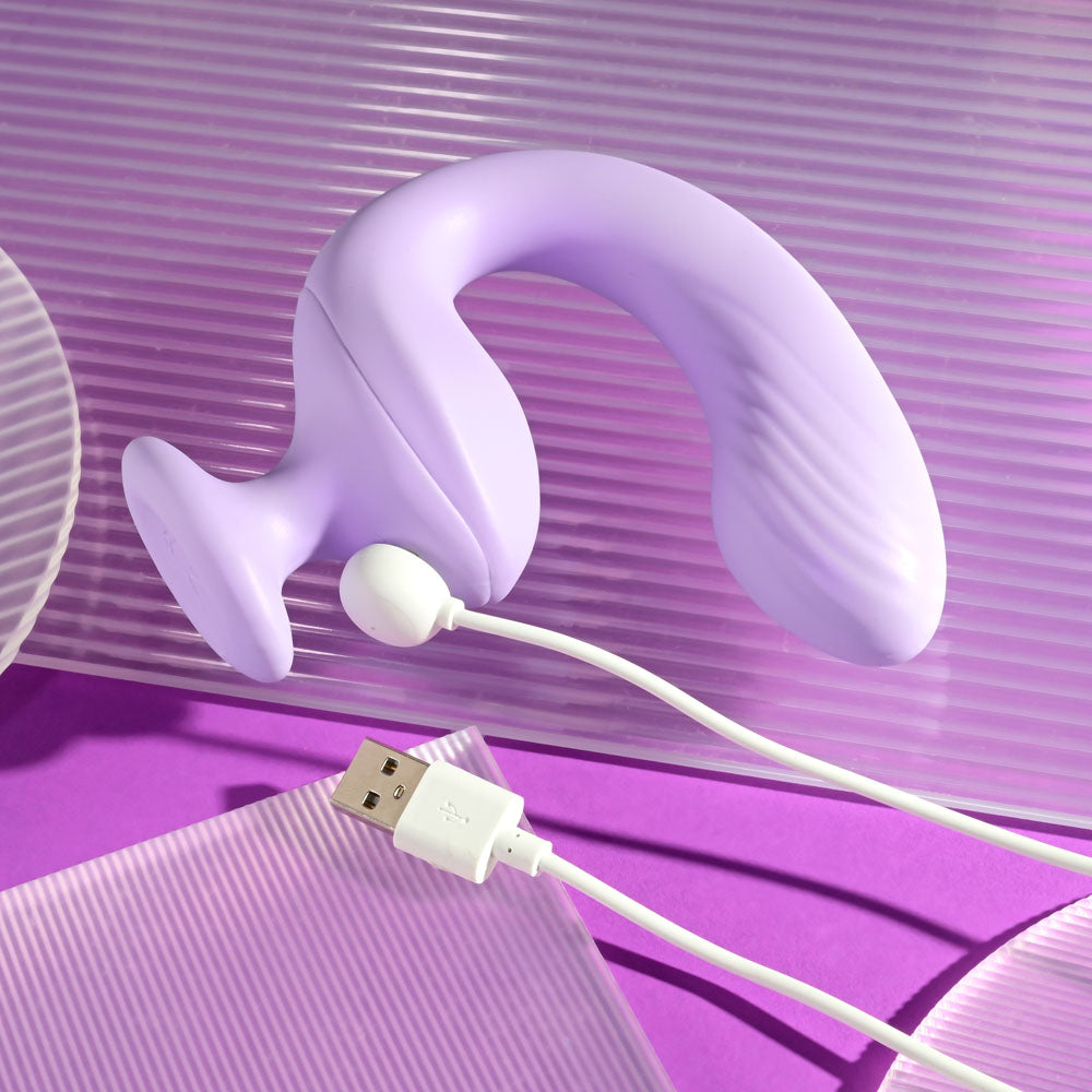 Playboy Pleasure REV ME UP - USB Rechargeable Dual Motor Curved Vibrator with charging cable on a purple background.