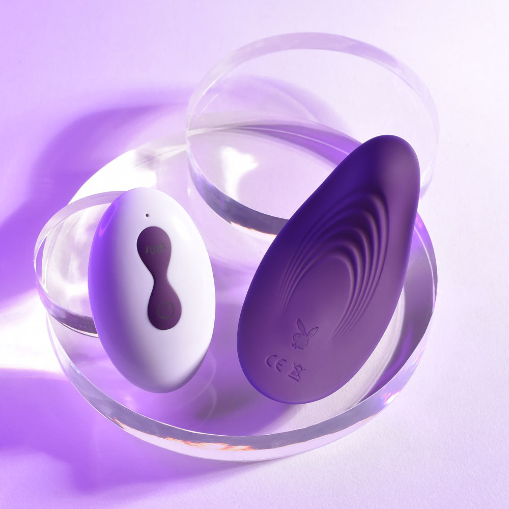 Playboy Pleasure OUR LITTLE SECRET -  USB Rechargeable Panty Vibrator with Wireless Remote Control on a display.