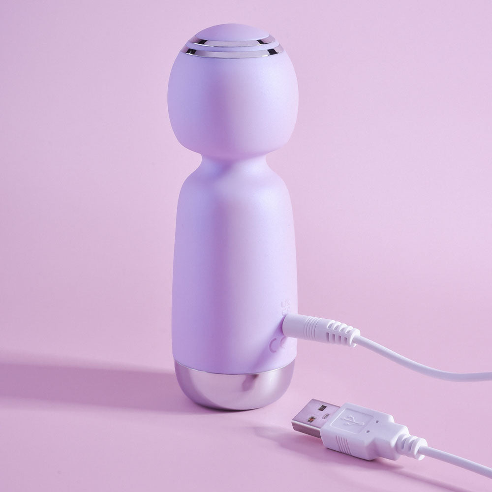 Playboy Pleasure ROYAL MINI - Lilac 12.5 cm USB Rechargeable Mini Wand Vibrator on a pastel background.