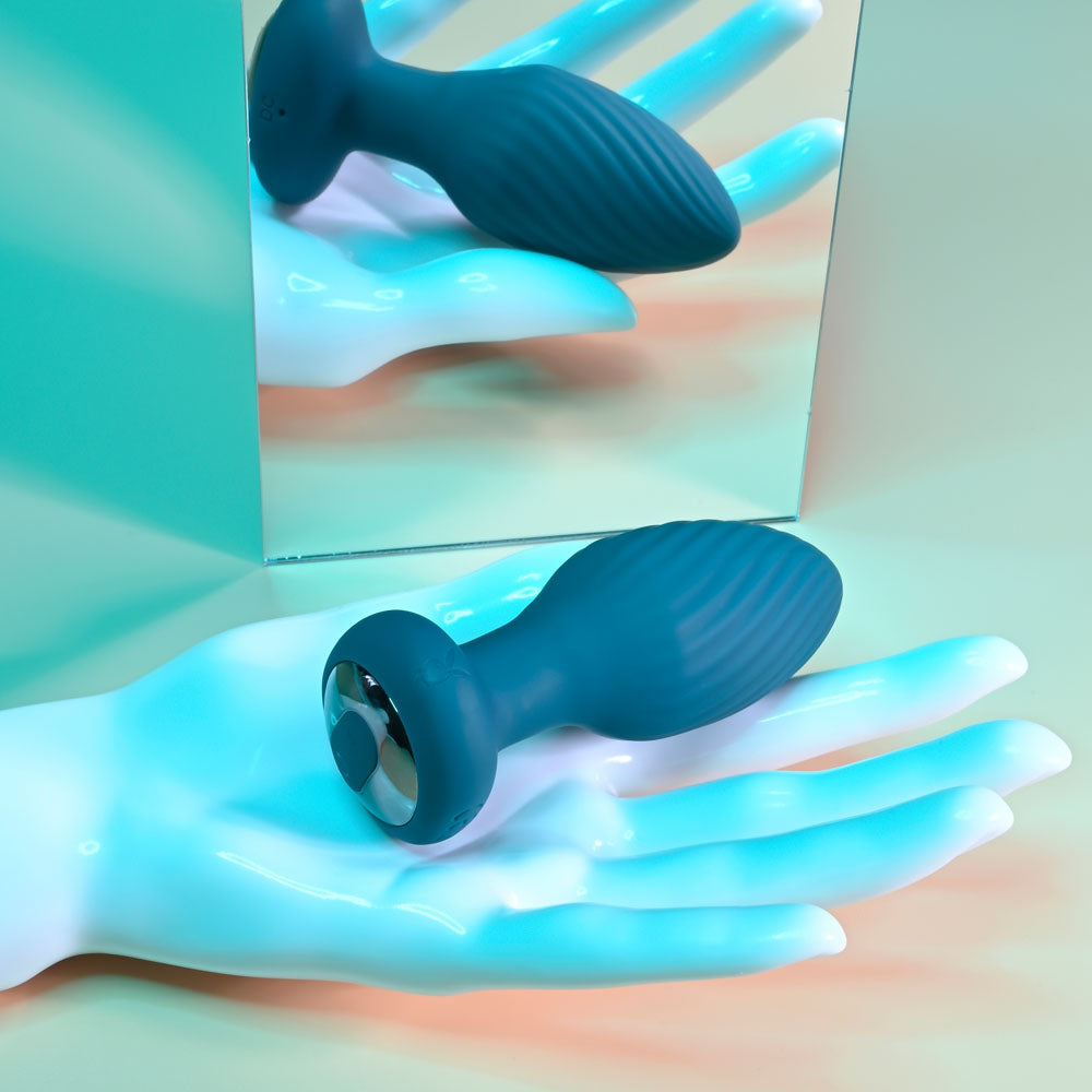 Playboy Pleasure SPINNING TAIL TEASER - 9.7 cm USB Rechargeable Vibrating & Rotating Butt Plug with Wireless Remote on a hand.