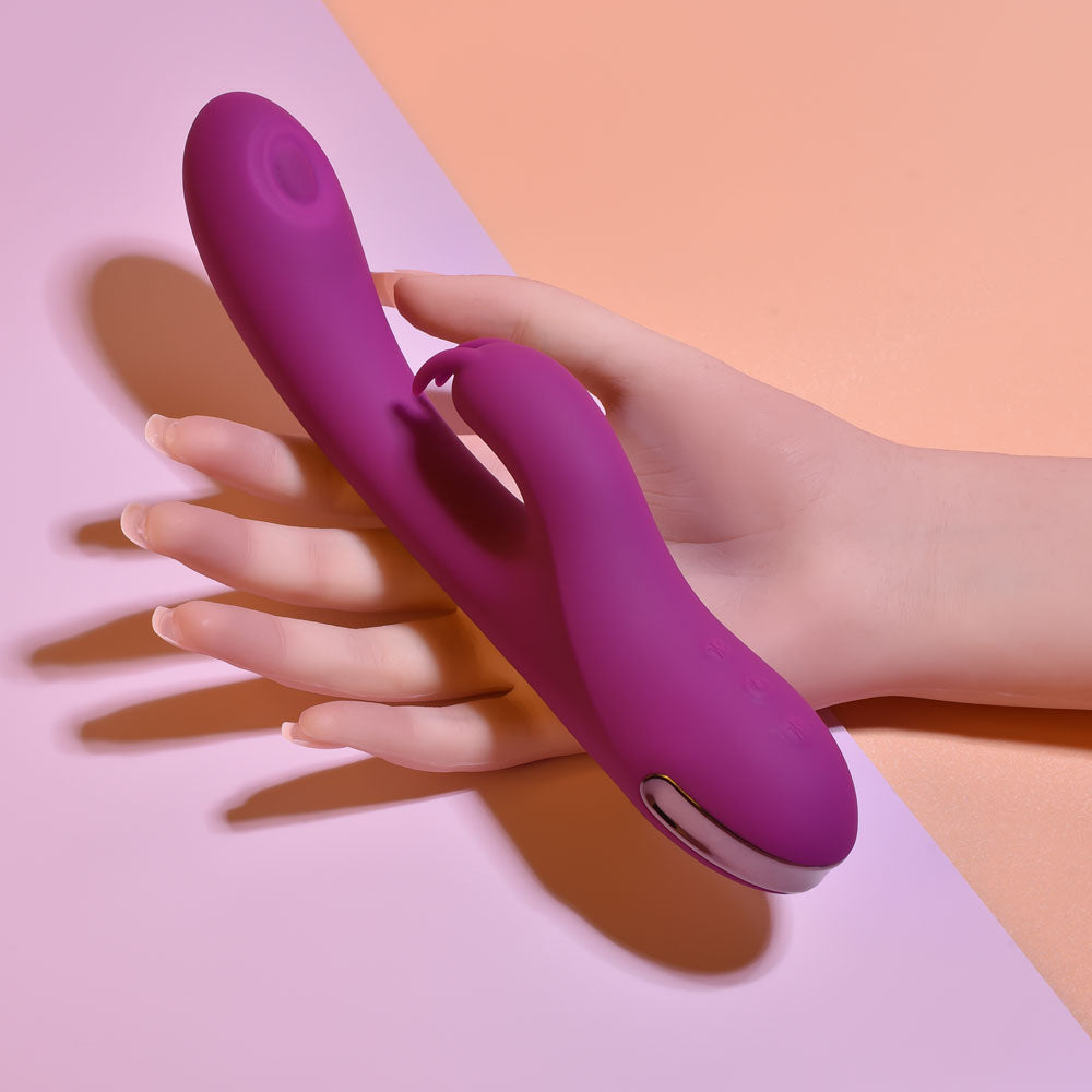 Playboy Pleasure THUMPER - 21.9 cm USB Rechargeable Rabbit Vibrator held in hand, showcasing its sleek design.