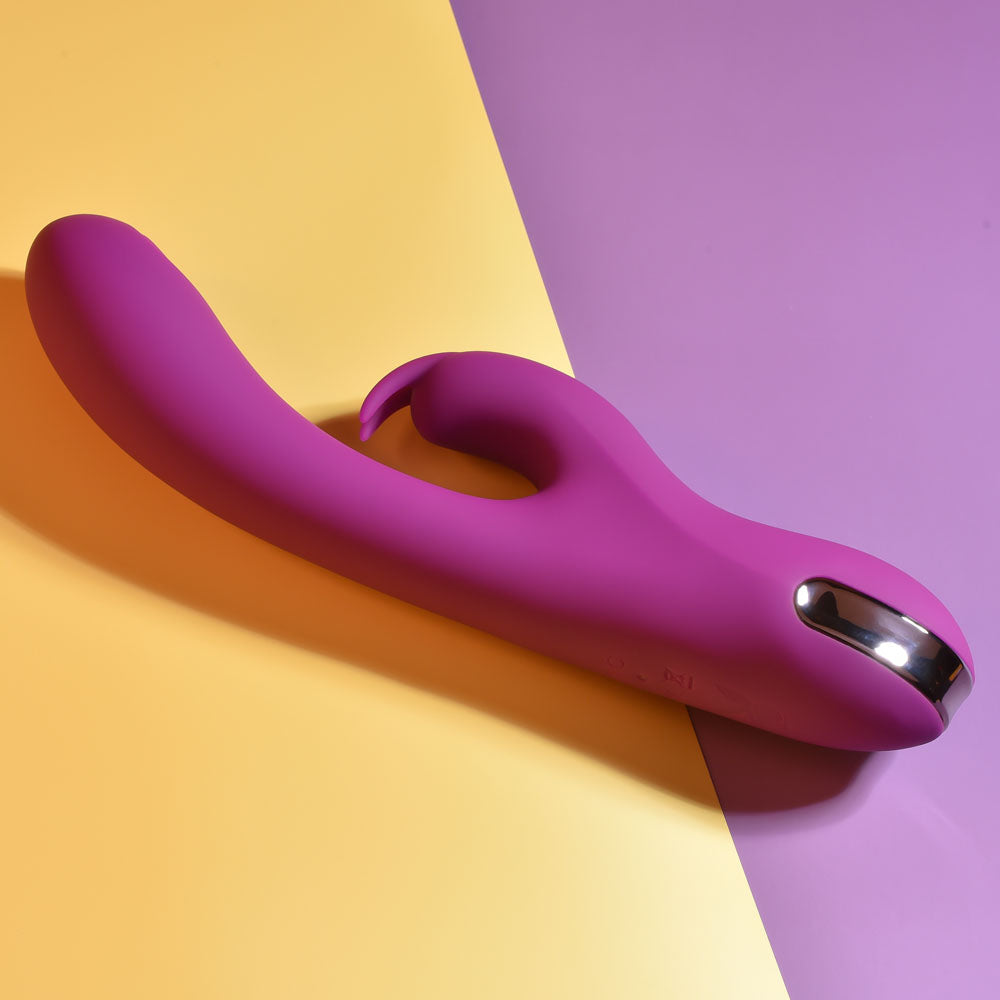 Playboy Pleasure THUMPER - 21.9 cm USB Rechargeable Rabbit Vibrator on a colorful background.