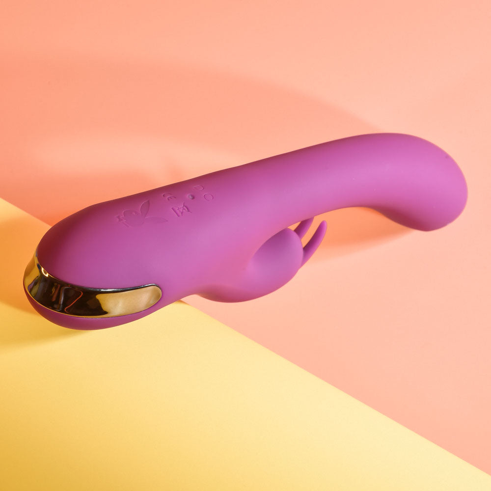 Playboy Pleasure THUMPER -  21.9 cm USB Rechargeable Rabbit Vibrator on a colorful background.