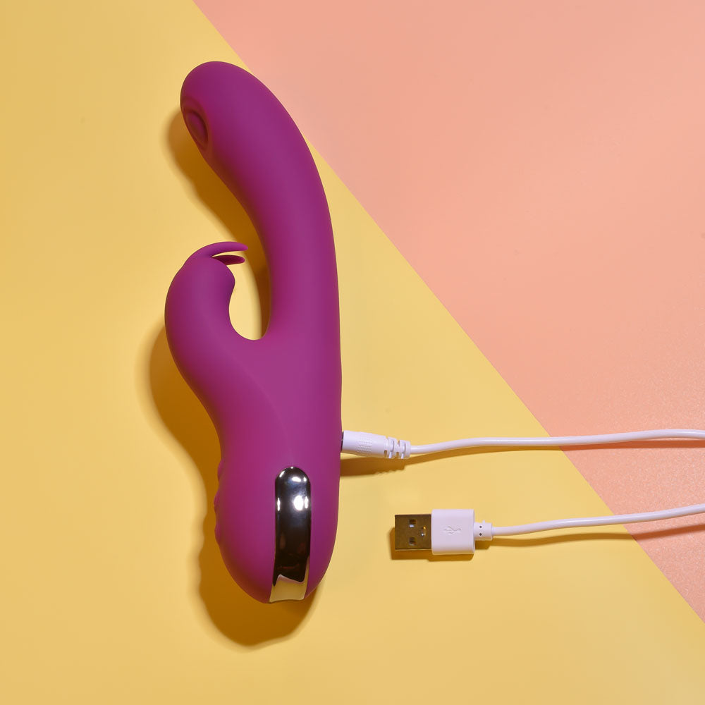 Playboy Pleasure THUMPER - 21.9 cm USB Rechargeable Rabbit Vibrator on a colorful background with USB charging cable.