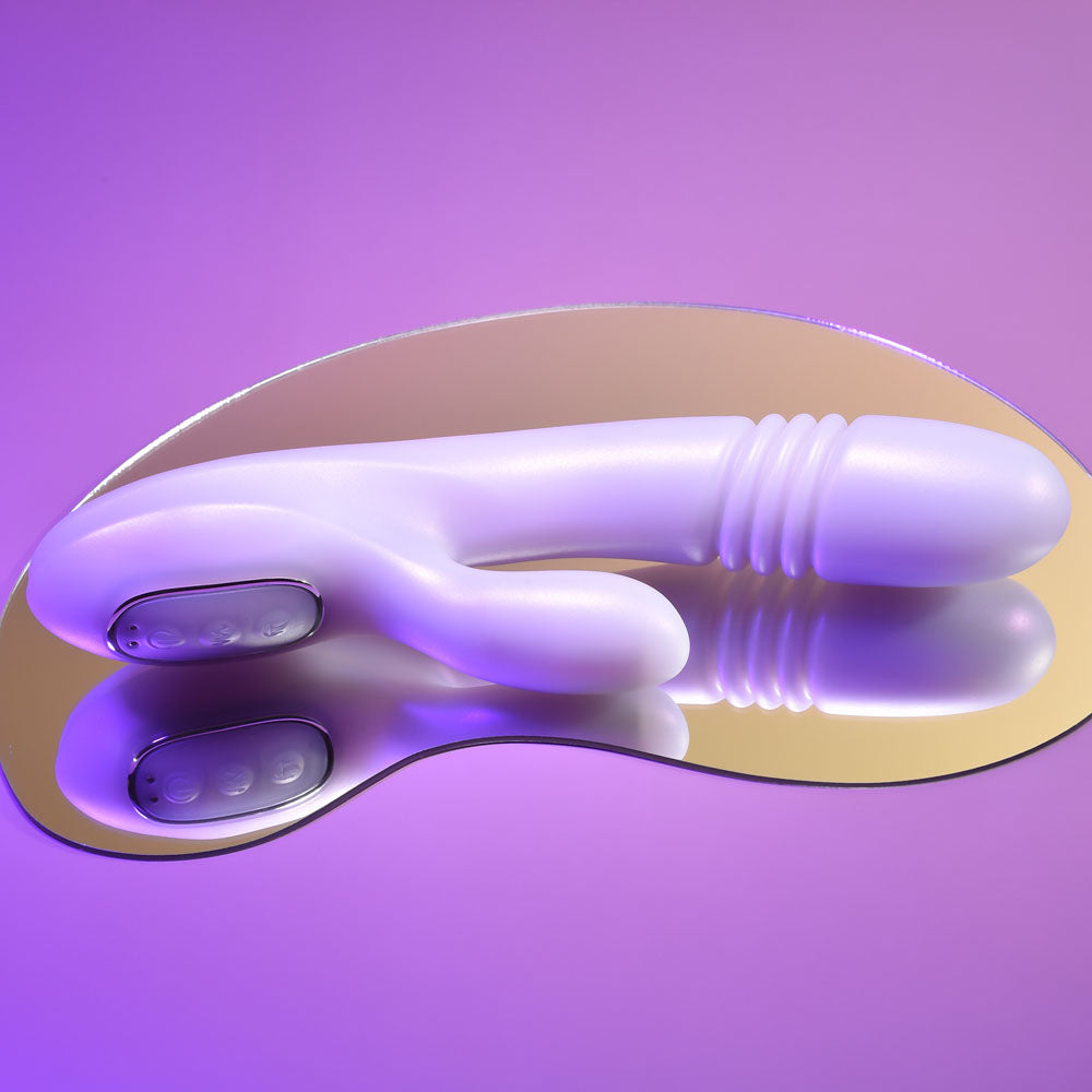 Playboy Pleasure BUMPING BUNNY - Opal 22.9 cm USB Rechargeable Thrusting & Warming Rabbit Vibrator on a mirrored surface