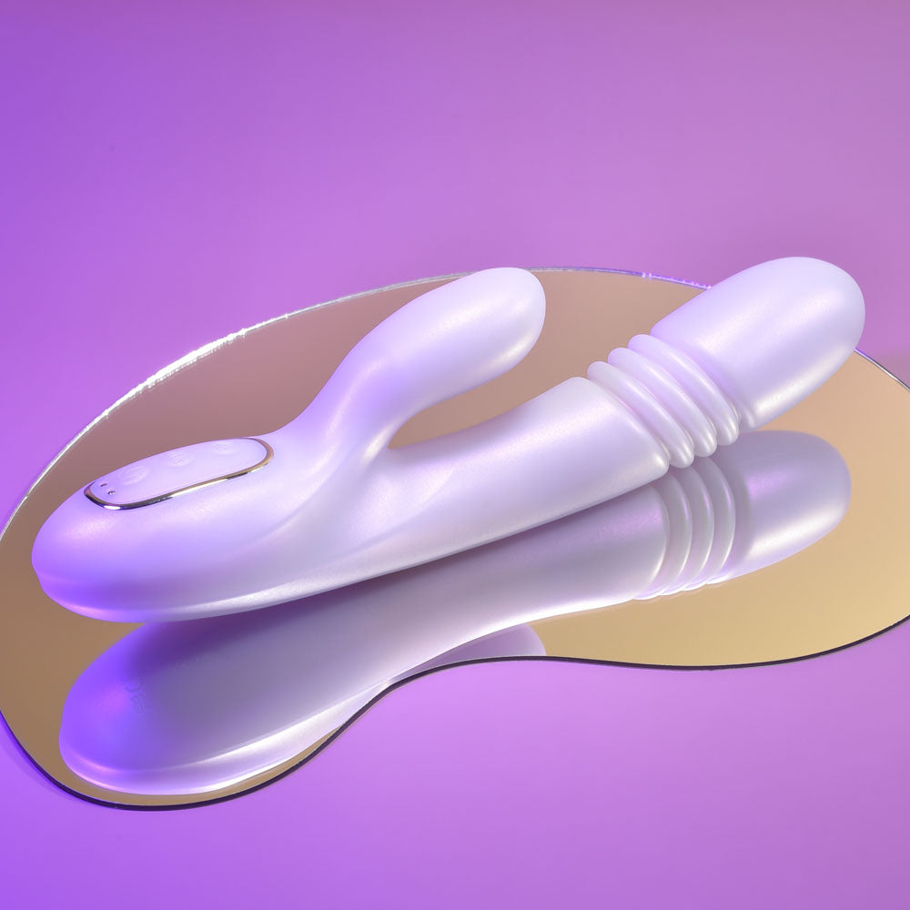 Playboy Pleasure BUMPING BUNNY - Opal 22.9 cm USB Rechargeable Thrusting & Warming Rabbit Vibrator on reflective surface.