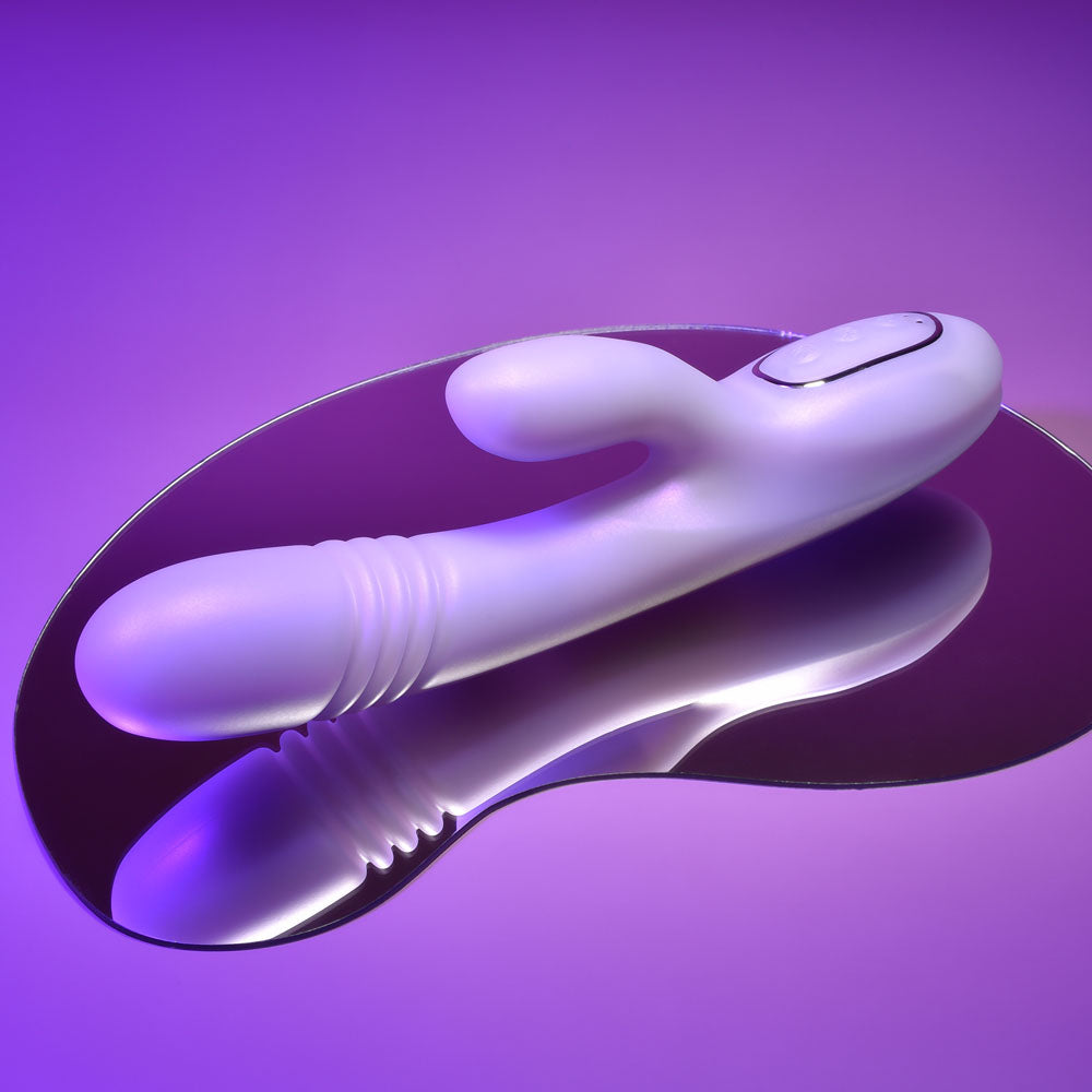Playboy Pleasure BUMPING BUNNY - Opal 22.9 cm USB Rechargeable Thrusting & Warming Rabbit Vibrator on a reflective surface.