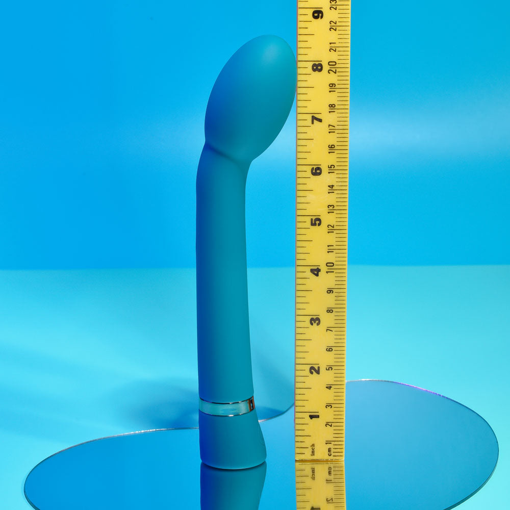 Playboy Pleasure ON THE SPOT - 21.6 cm USB Rechargeable G-Spot Vibrator next to a ruler on a reflective surface.