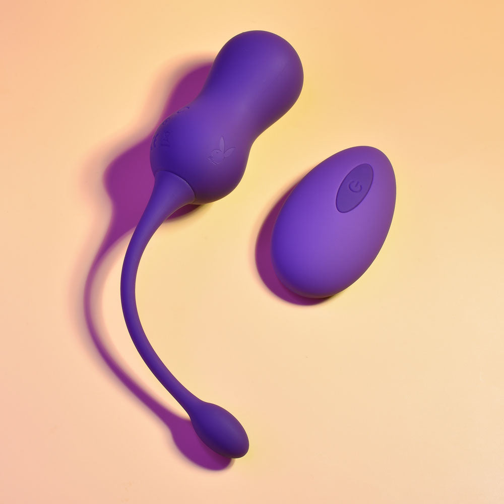 Playboy Pleasure DOUBLE TIME - USB Rechargeable Vibrating Kegel Balls in purple with remote control.