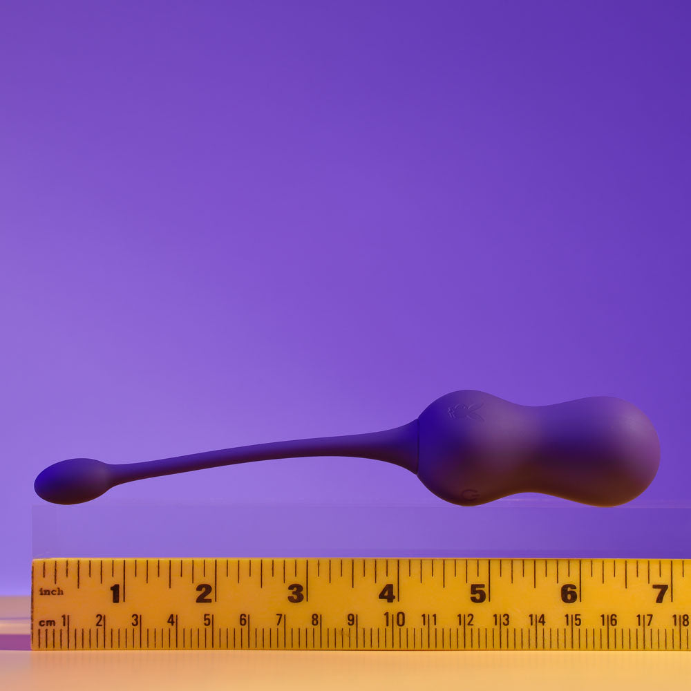 Playboy Pleasure DOUBLE TIME - USB Rechargeable Vibrating Kegel Balls on ruler, showcasing its double-bulb shape and retrieval cord.